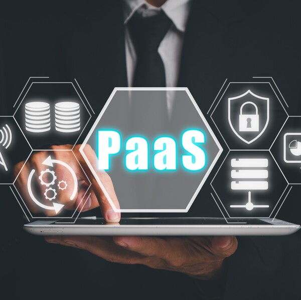 PaaS - Platform as a service, Businessman working on digital tablet with PaaS icon on VR screen on desk background, Internet technology and development concept.
